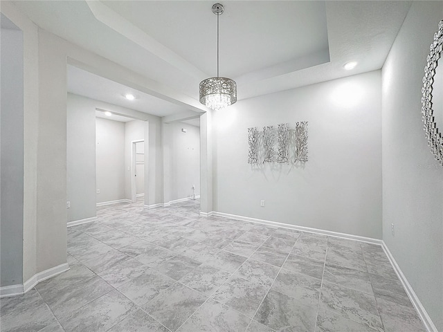 unfurnished room with a tray ceiling