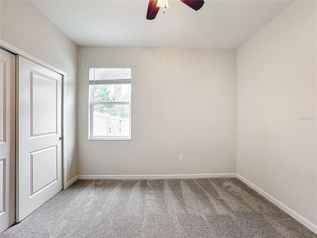 spare room featuring carpet floors and ceiling fan