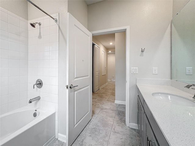 bathroom with tiled shower / bath and vanity