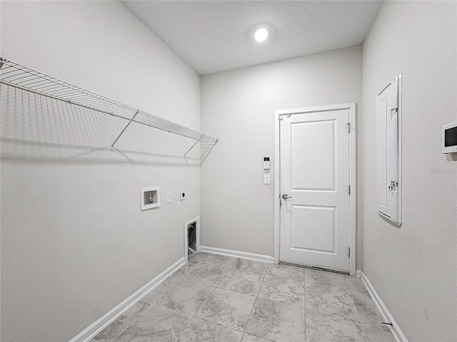 washroom with electric dryer hookup, hookup for a washing machine, and a textured ceiling