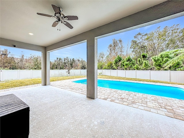 view of swimming pool with ceiling fan and a patio area