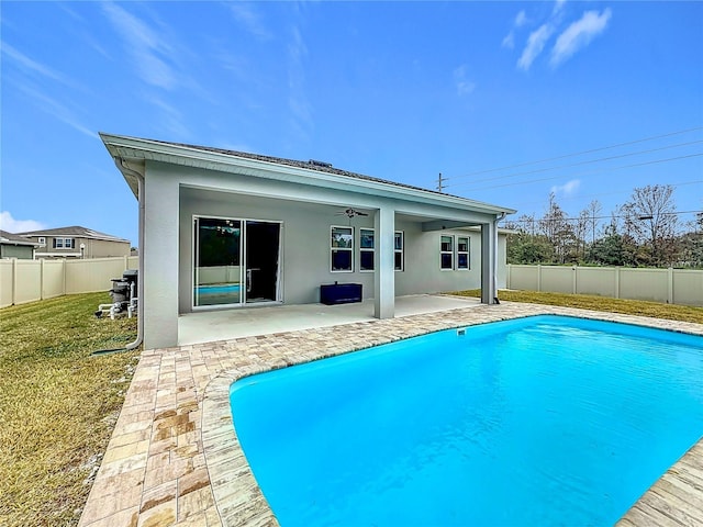 view of swimming pool featuring ceiling fan, a patio area, and a yard