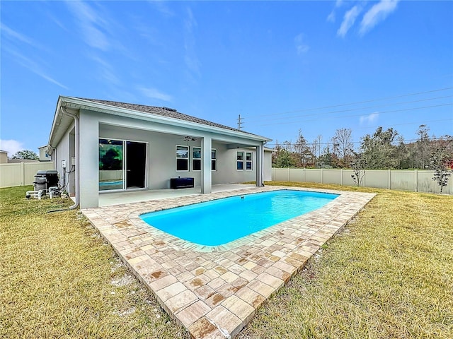 view of swimming pool with a lawn, ceiling fan, and a patio