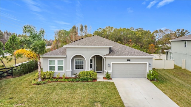 view of front of home featuring a front lawn and a garage