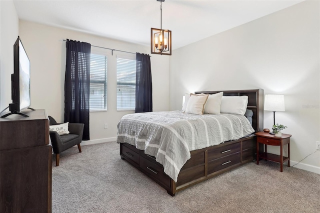 bedroom featuring a notable chandelier and light carpet