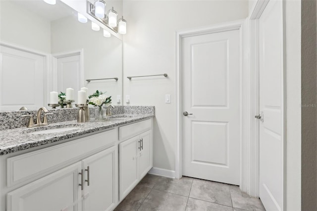 bathroom featuring tile patterned flooring and vanity