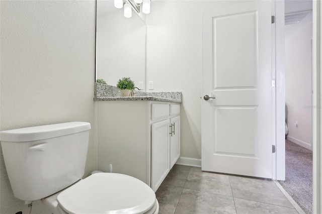 bathroom featuring toilet, vanity, and tile patterned floors