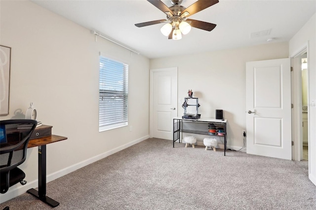 carpeted office featuring ceiling fan