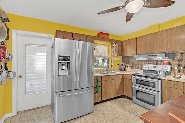 kitchen with ceiling fan, appliances with stainless steel finishes, backsplash, and sink