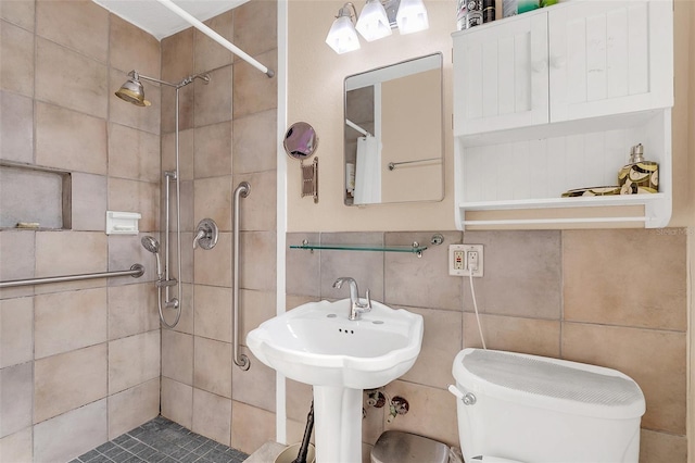 bathroom featuring toilet, tile walls, and tiled shower