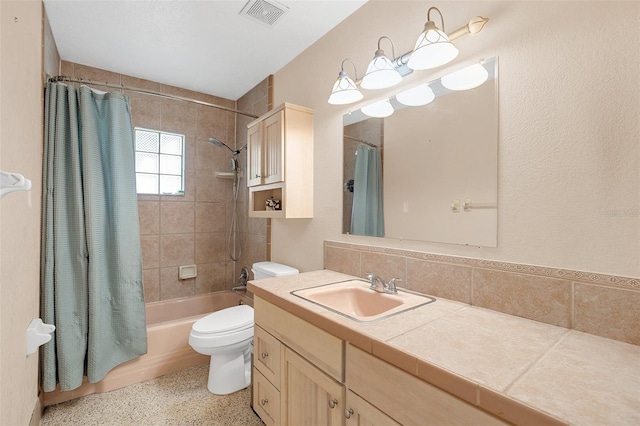 full bathroom featuring toilet, decorative backsplash, vanity, and shower / bath combo with shower curtain