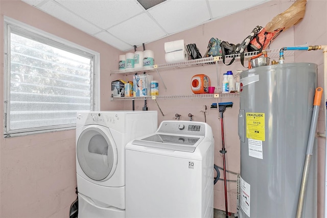 washroom featuring electric water heater and washer and dryer