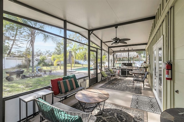 sunroom featuring ceiling fan