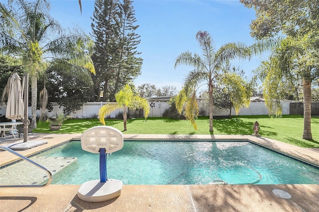 view of pool featuring a lawn