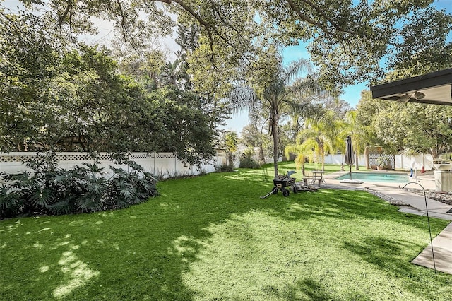 view of yard with a fenced in pool