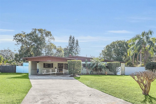 view of front facade featuring a front yard and a carport