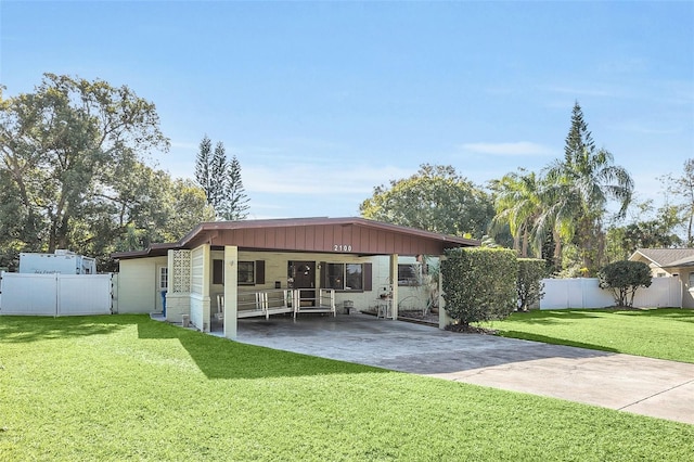 exterior space with a carport and a yard