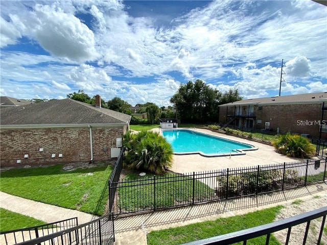 view of swimming pool featuring a patio area and a lawn