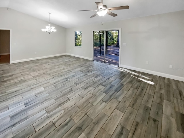 unfurnished room featuring ceiling fan with notable chandelier and vaulted ceiling