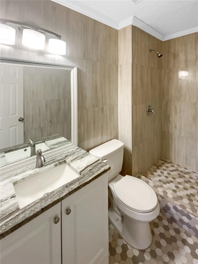 bathroom with walk in shower, crown molding, toilet, vanity, and tile walls