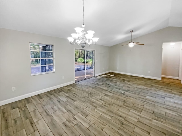 unfurnished room with ceiling fan with notable chandelier and vaulted ceiling