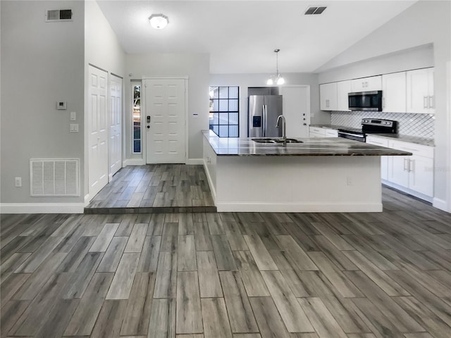 kitchen featuring white cabinetry, sink, pendant lighting, lofted ceiling, and appliances with stainless steel finishes