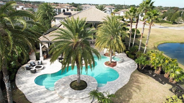 view of swimming pool with an outdoor fire pit, a patio area, and a lawn