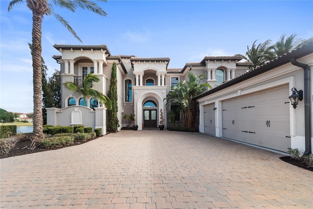 mediterranean / spanish-style house with french doors and a garage