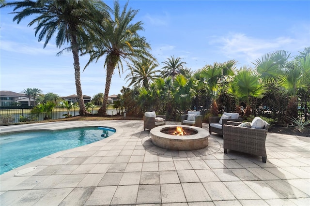 view of swimming pool featuring an outdoor fire pit and a patio area