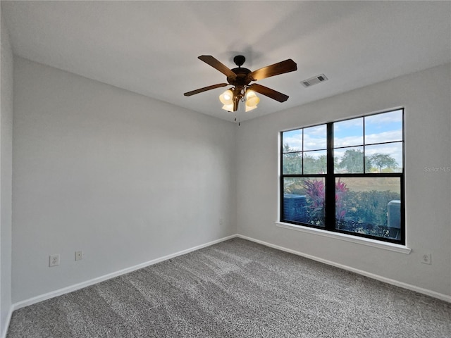 carpeted spare room with ceiling fan