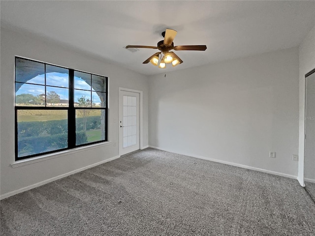 empty room featuring carpet flooring and ceiling fan