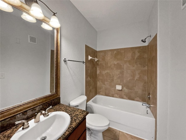 full bathroom featuring tile patterned flooring, vanity, tiled shower / bath combo, and toilet