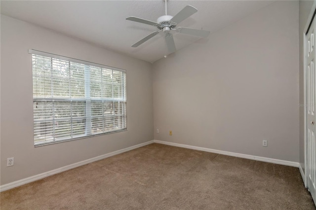 carpeted spare room with ceiling fan