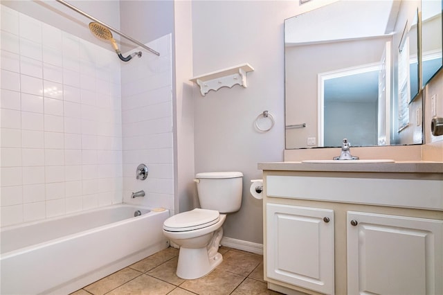 full bathroom featuring toilet, vanity, tiled shower / bath combo, and tile patterned flooring