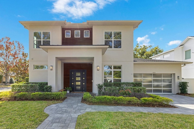 view of front facade with a garage and a front lawn