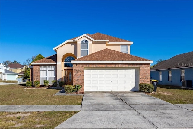 view of front property featuring cooling unit, a front yard, and a garage