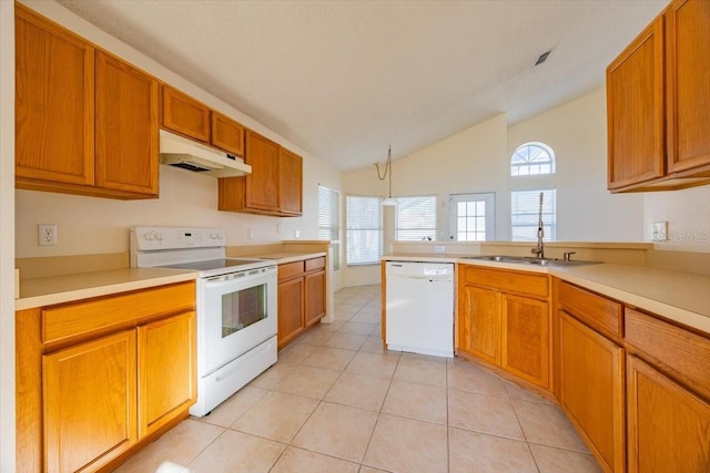 kitchen with kitchen peninsula, white appliances, sink, light tile patterned floors, and lofted ceiling