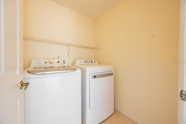 laundry room with light tile patterned floors and washer and dryer