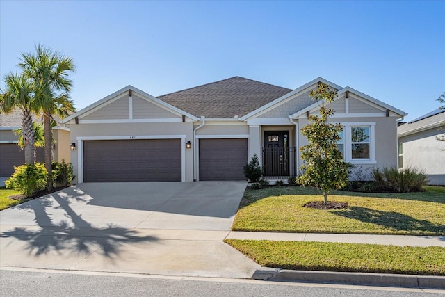 view of front of home with a garage and a front lawn