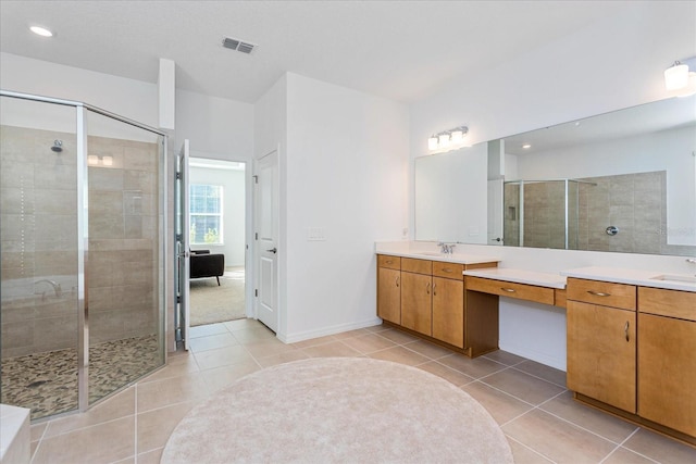 bathroom with tile patterned floors, vanity, and an enclosed shower