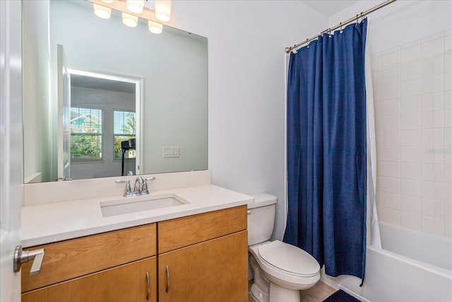 full bathroom with vanity, shower / tub combo, and toilet