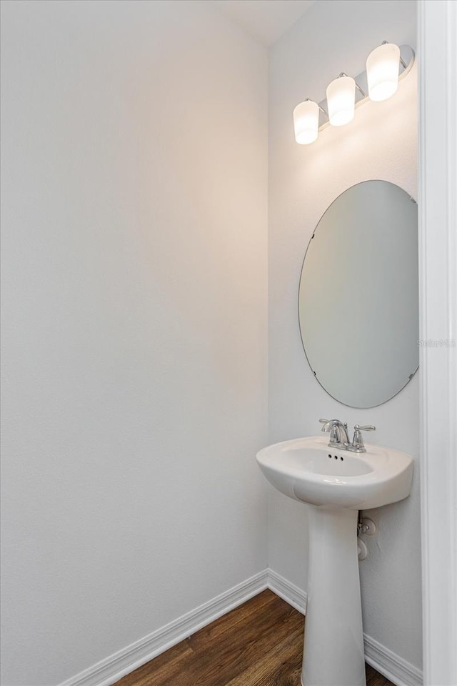 bathroom with hardwood / wood-style flooring