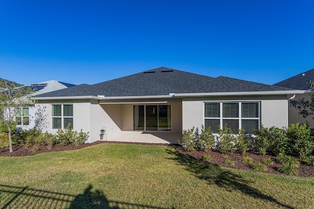 back of property featuring a yard and a patio area