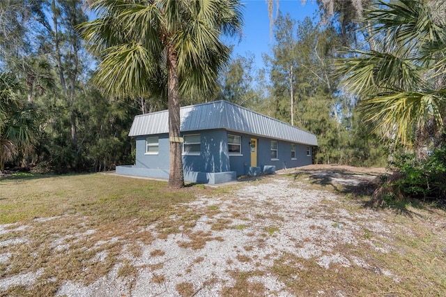 view of side of home featuring a yard