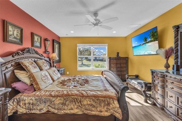 bedroom with ceiling fan and light wood-type flooring