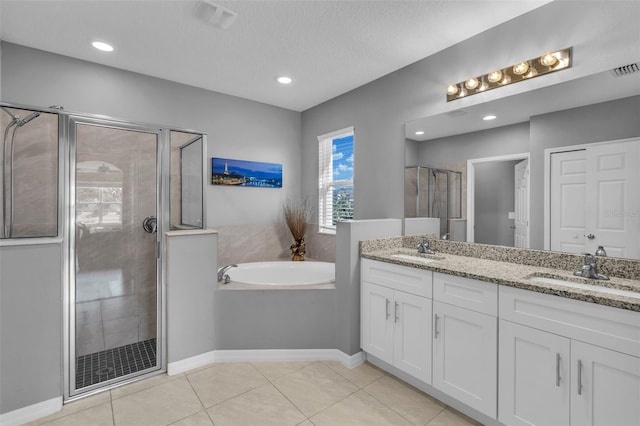 bathroom featuring tile patterned floors, vanity, separate shower and tub, and a textured ceiling