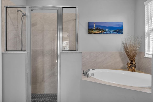 bathroom featuring a wealth of natural light and independent shower and bath