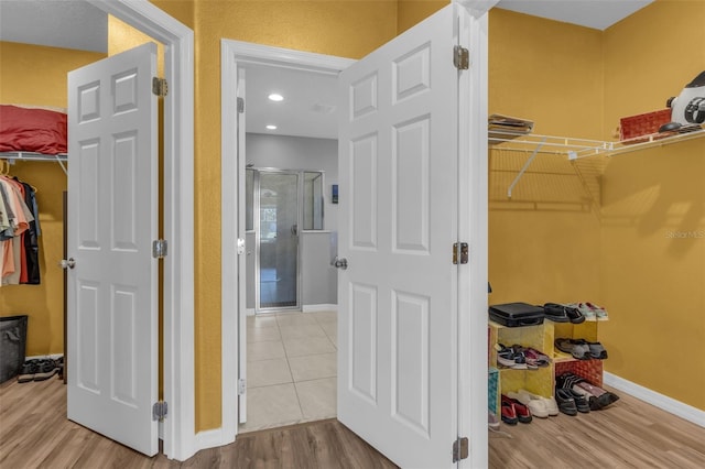 spacious closet with light hardwood / wood-style flooring