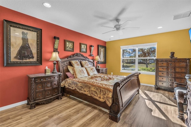 bedroom with hardwood / wood-style flooring and ceiling fan