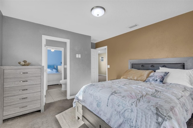 carpeted bedroom featuring connected bathroom